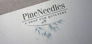 Logo for Pine Needles Quilting Shop - Bend, Oregon
